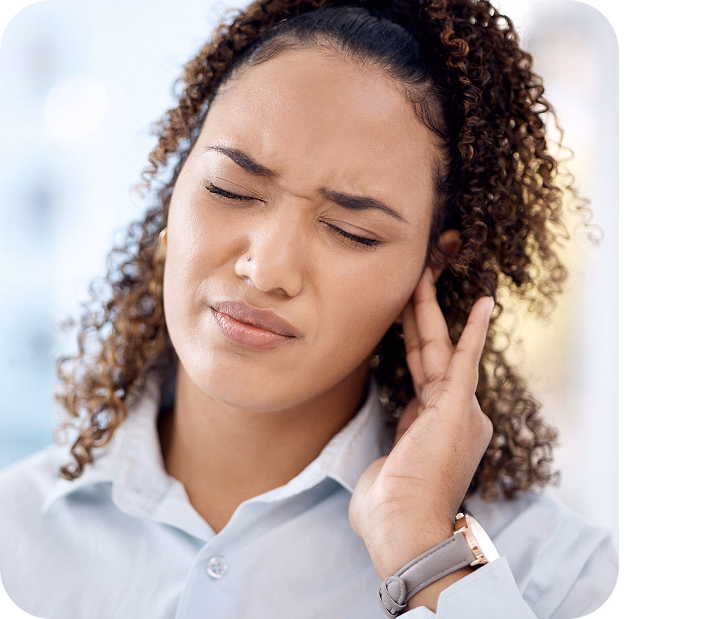 Woman experiencing discomfort and touching her head, indicating a symptom of brain injury such as pain or sensory issues.