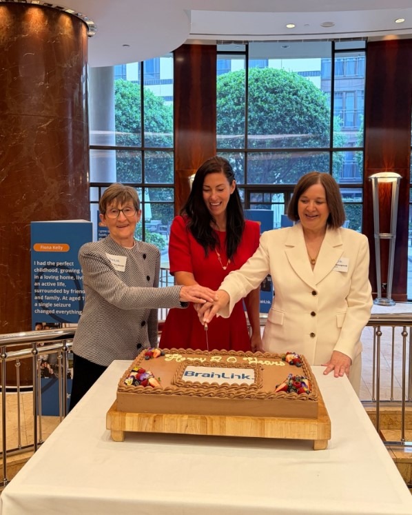 BrainLink CEO Sharon Strugnell, BrainLink Chairperson Suzanne Suzanne Hasthorpe and Minister for Youth and Minister for Carers and Volunteers Luba Grigorovitch cut the cake, celebrating BrainLinks 20th year. 